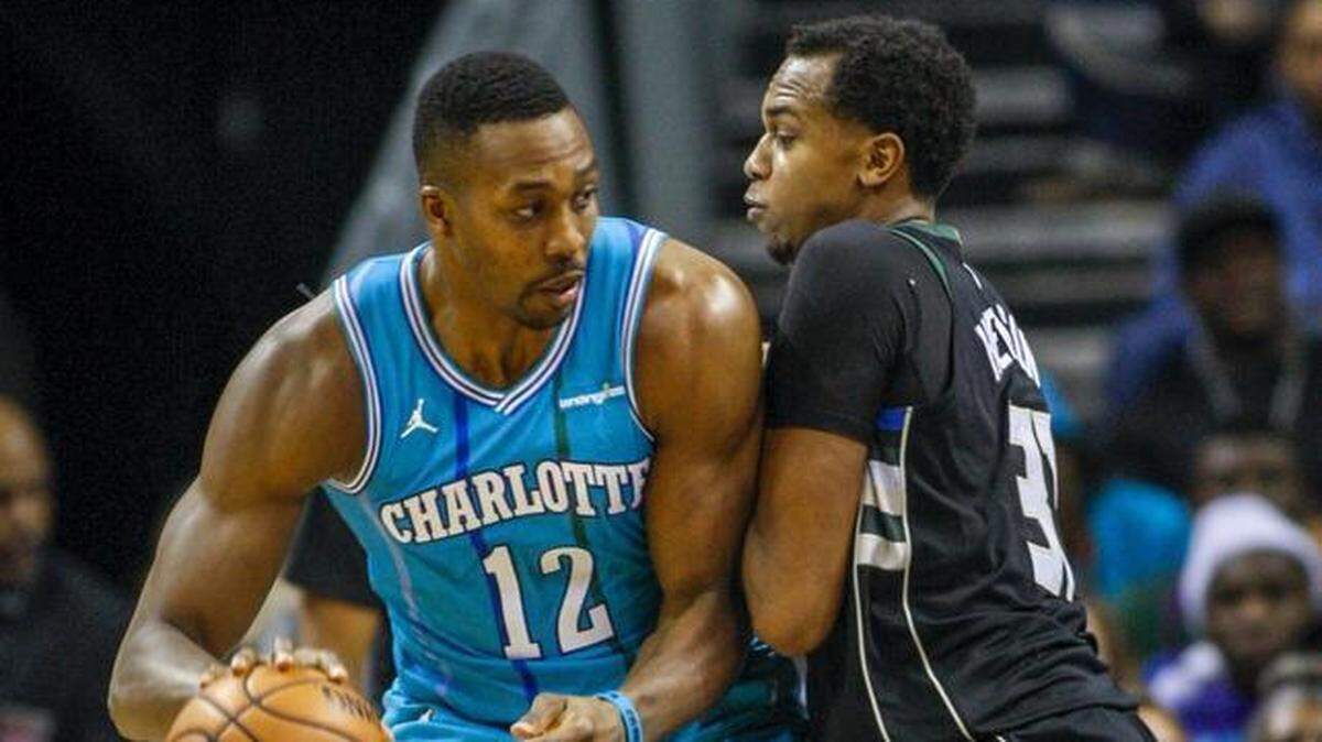 Charlotte Hornets center Dwight Howard, left, finished Saturday’s game against Milwaukee with 21 points and 16 rebounds, which is impressive enough on paper in its own right. But to do so with a banged-up finger – and also to lead a Hornets comeback from down 18 points – is its own feat.