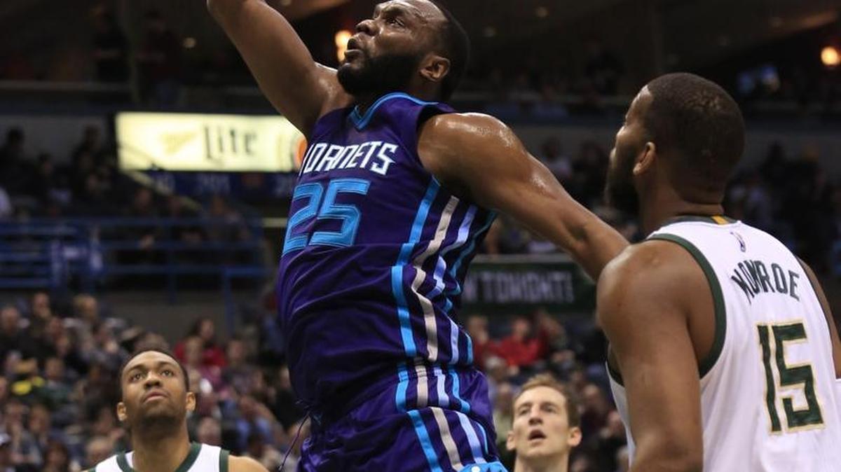 Charlotte Hornets center Al Jefferson, center, gets a slam dunk against the Milwaukee Bucks during the first half of an NBA basketball game Friday in Milwaukee.