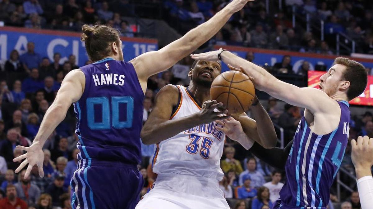 Oklahoma City Thunder forward Kevin Durant (35) is fouled as he drives between Charlotte Hornets forward Spencer Hawes (00) and center Frank Kaminsky, right, on Wednesday in Oklahoma City.