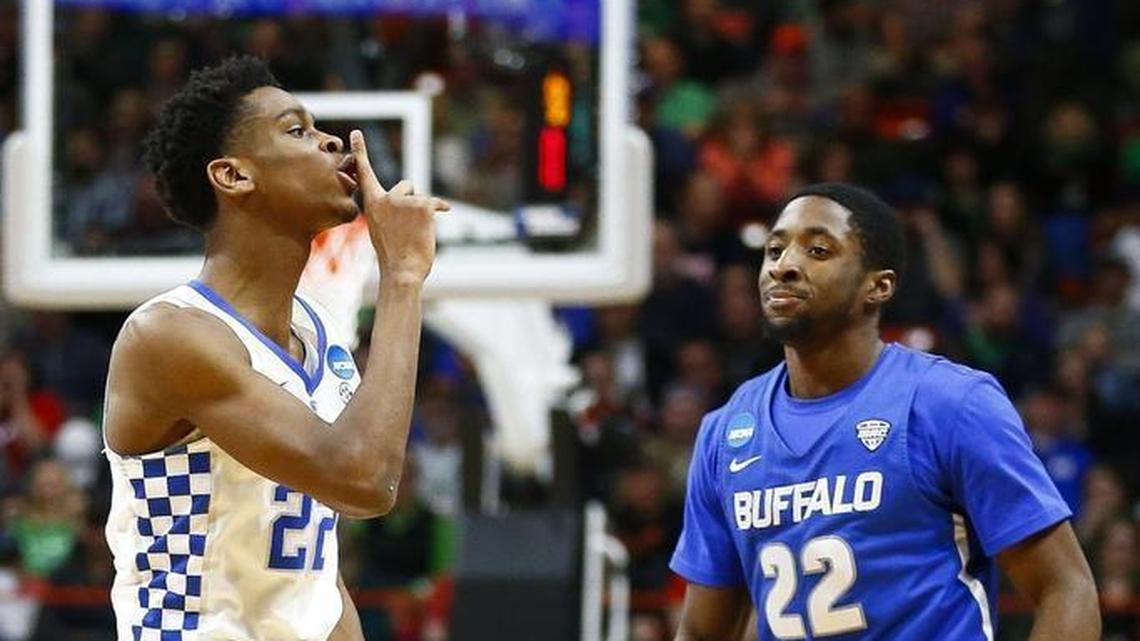 Kentucky Wildcats guard Shai Gilgeous-Alexander, left, holds his finger to his mouth in the “shush” sign after hitting a 3 late in the second half of Saturday’s NCAA tournament game against Buffalo. “I’m a competitor. The crowd was pro-Buffalo,” Gilgeous-Alexander said.