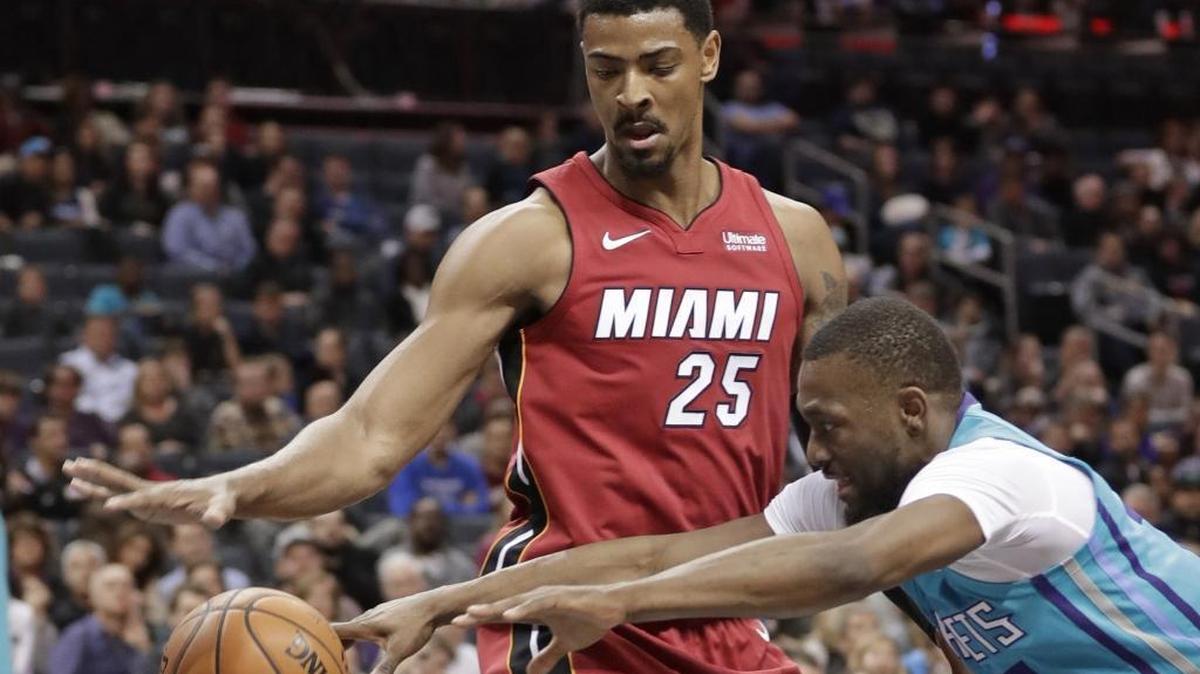 Charlotte Hornets' Kemba Walker (15) and Miami Heat's Jordan Mickey (25) chase the ball during the first half of Friday’s game at Spectrum Center. Walker injured his left wrist in the second quarter.