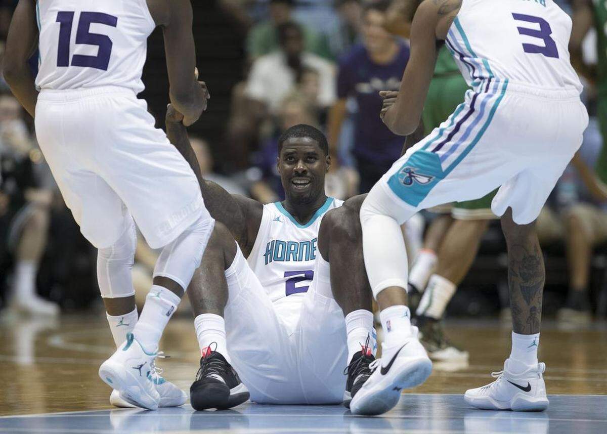 Charlotte’s Kemba Walker (15) and Jeremy Lamb (3) help teammate Marvin Williams (2) to his feet during their NBA exhibition against the Boston Celtics on Friday at the Smith Center in Chapel Hill. Charlotte won 104-97.
