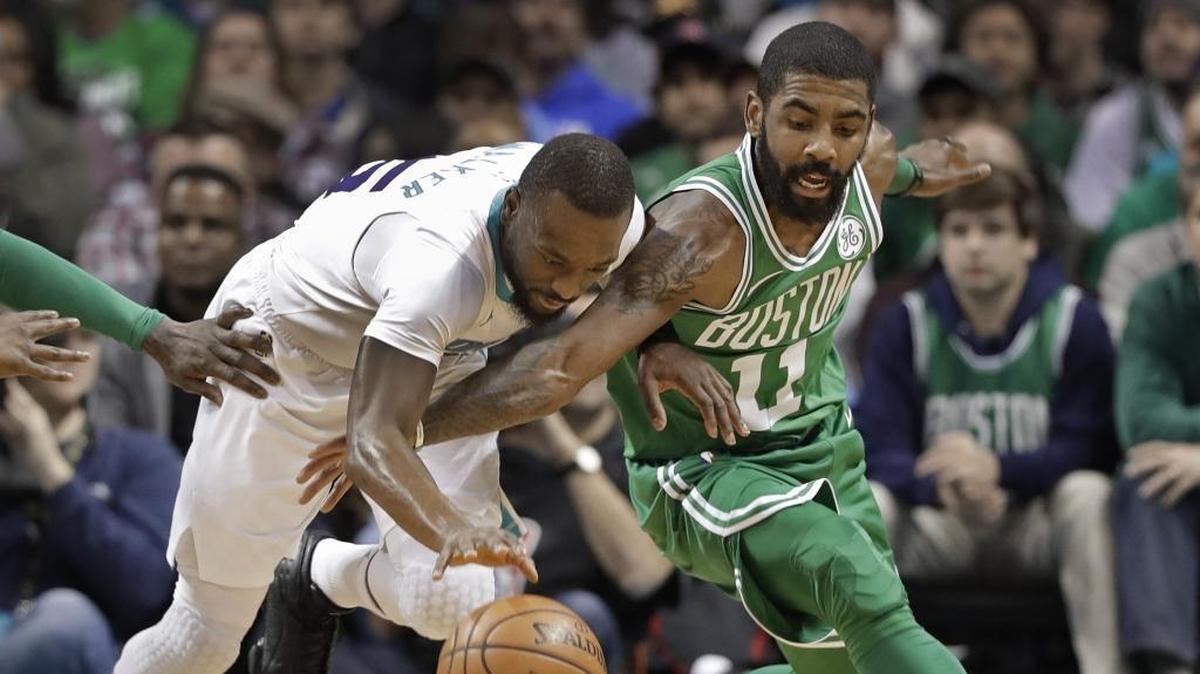 Charlotte Hornets' Kemba Walker, left, and Boston Celtics' Kyrie Irving, right, battle for the ball during the first half of Wednesday’s game at Spectrum Center.