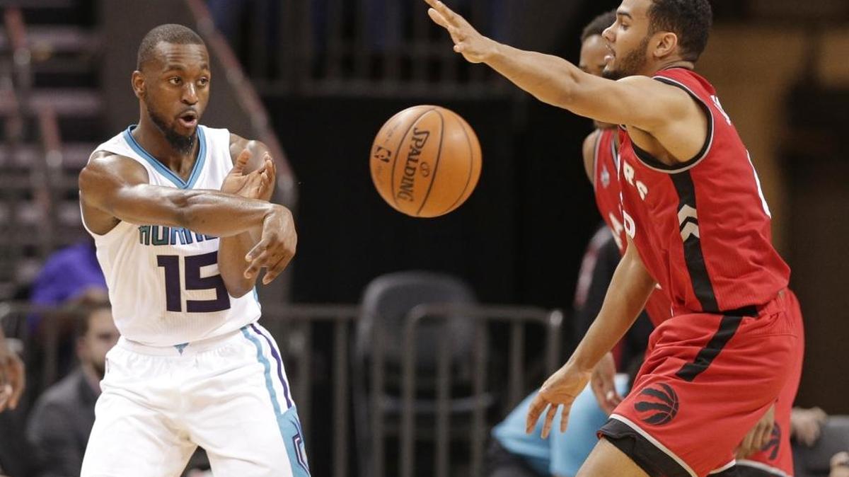 Charlotte Hornets' Kemba Walker (15) passes the ball around Toronto Raptors' Cory Joseph (6) in the second half of Thursday’s game in Charlotte. The Hornets won 109-99 in overtime.