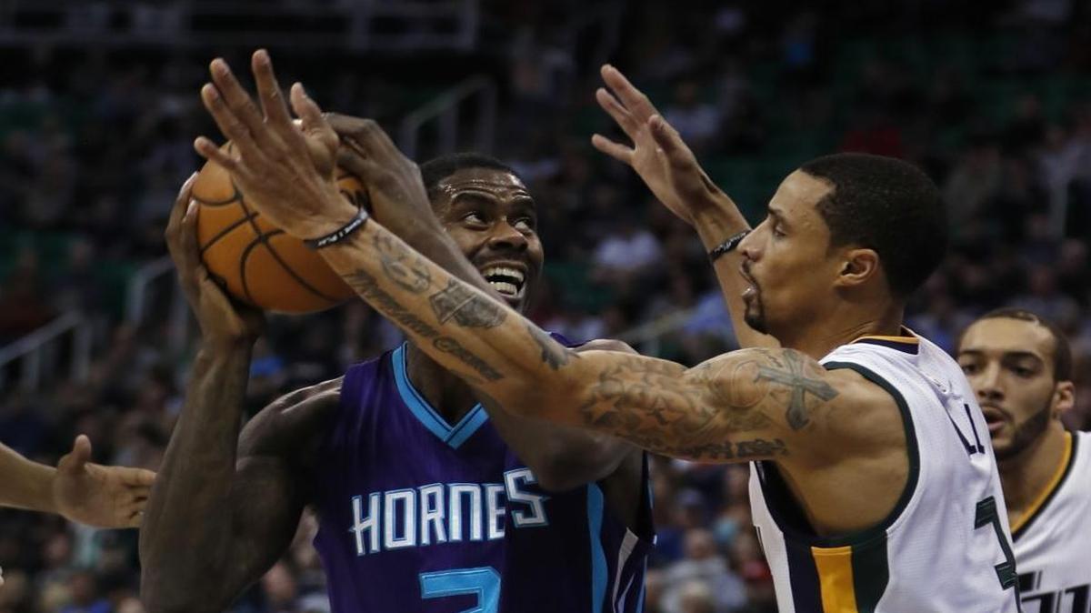 Charlotte Hornets forward Marvin Williams (2) looks to shoot over Utah Jazz guard George Hill (3) during Saturday’s game in Salt Lake City.