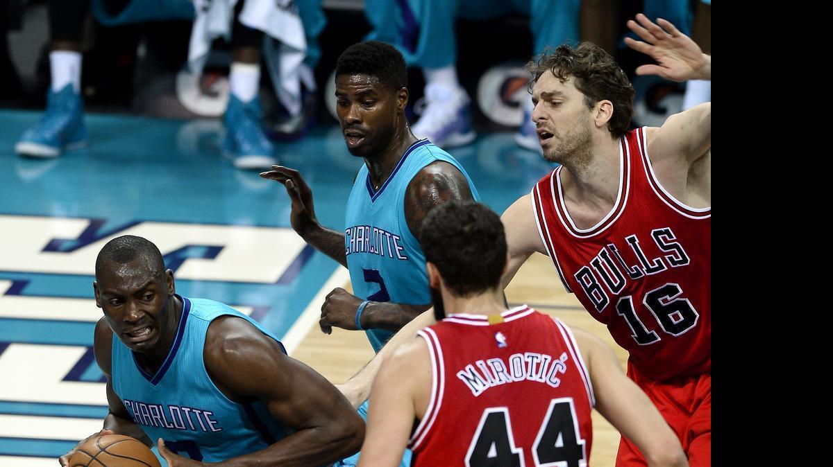 
Former Charlotte Hornets forward/center Bismack Biyombo (8) fights for position under the basket for a shot as Chicago Bulls forward/center Pau Gasol (16) and forward Nikola Mirotic (44) apply defensive pressure on Friday March 13, 2015 at Time Warner Cable Arena in Charlotte, NC. 
