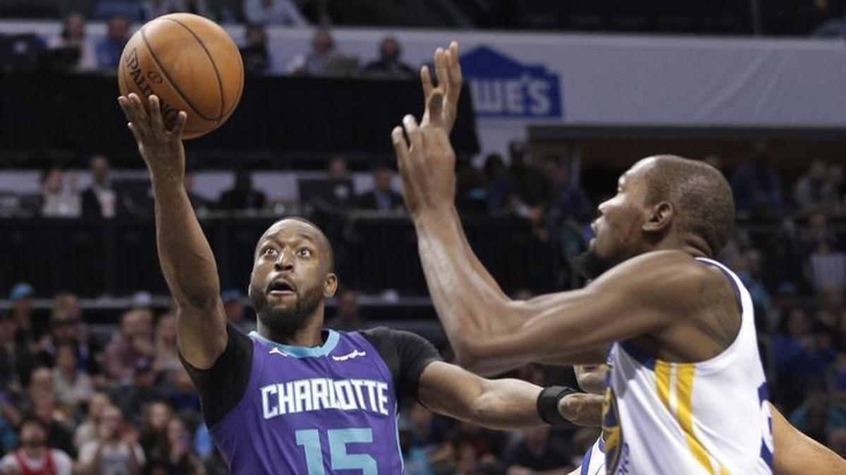 Charlotte Hornets' Kemba Walker (15) drives on Golden State Warriors' Kevin Durant (35) during the first half of Wednesday’s game at Spectrum Center.