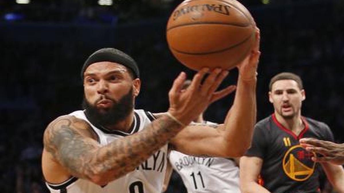 
Brooklyn Nets guard Deron Williams (8) looks to pass to the perimeter as he falls to the floor in the second half of an NBA basketball game against the Golden State Warriors at the Barclays Center, Monday, March 2, 2015, in New York. Williams had 22 points as the Nets defeated the Warriors 110-108.
