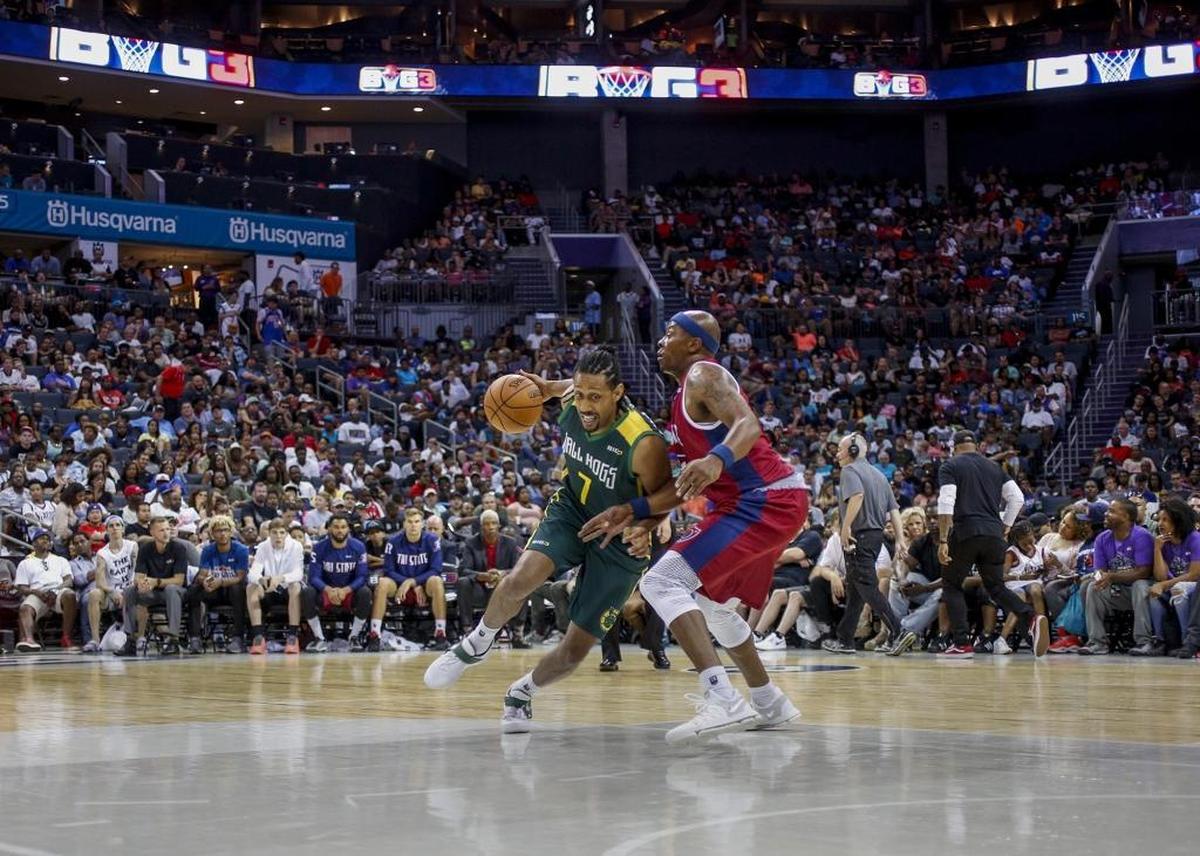 Ball Hogs player Josh Childress, left, drives around Tri-States player Mike James in Sunday’s Big 3 basketball tournament at the Spectrum Center.