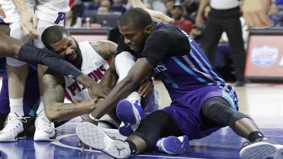 Detroit Pistons forward Marcus Morris and Charlotte Hornets forward Michael Kidd-Gilchrist fight for a loose ball during the second half of Thursday’s game in Auburn Hills, Mich.