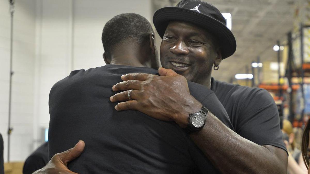 Charlotte Hornets owner Michael Jordan greets a fan as he made an appearance Friday at Second Harvest Food Bank of Metrolina. The Charlotte Hornets basketball team packed food boxes as part of Hurricane Florence relief efforts.
