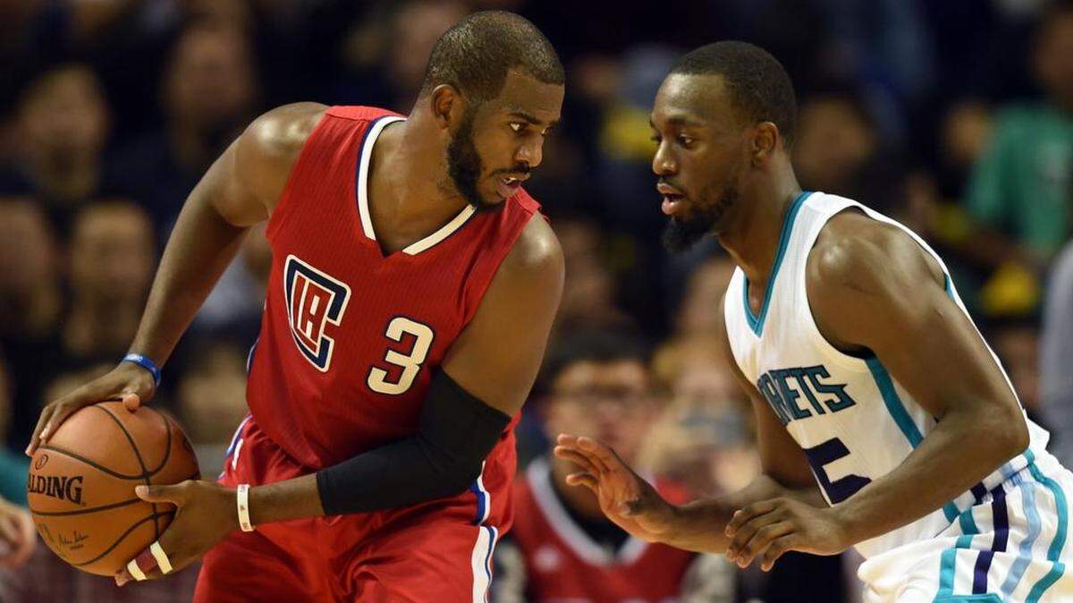 Kemba Walker (R) of the Charlotte Hornets guards Chris Paul of the Los Angeles Clippers during their 2015 NBA Global Games China pre-season basketball match in Shanghai on October 14, 2015. JOHANNES EISELEJOHANNES EISELE /AFP/ Getty Images