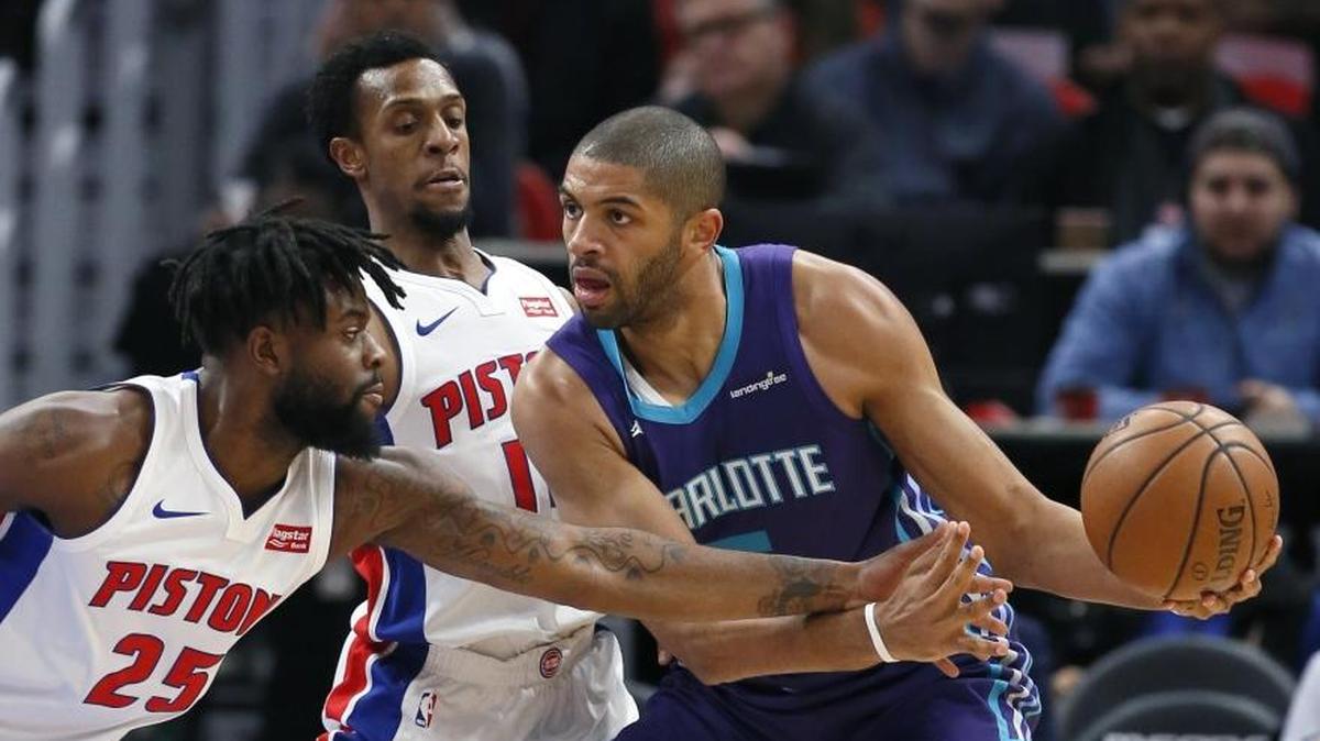 Charlotte Hornets guard Nic Batum (5) is surrounded by Detroit Pistons Reggie Bullock (25) and Ish Smith during Monday’s afternoon game in Detroit.