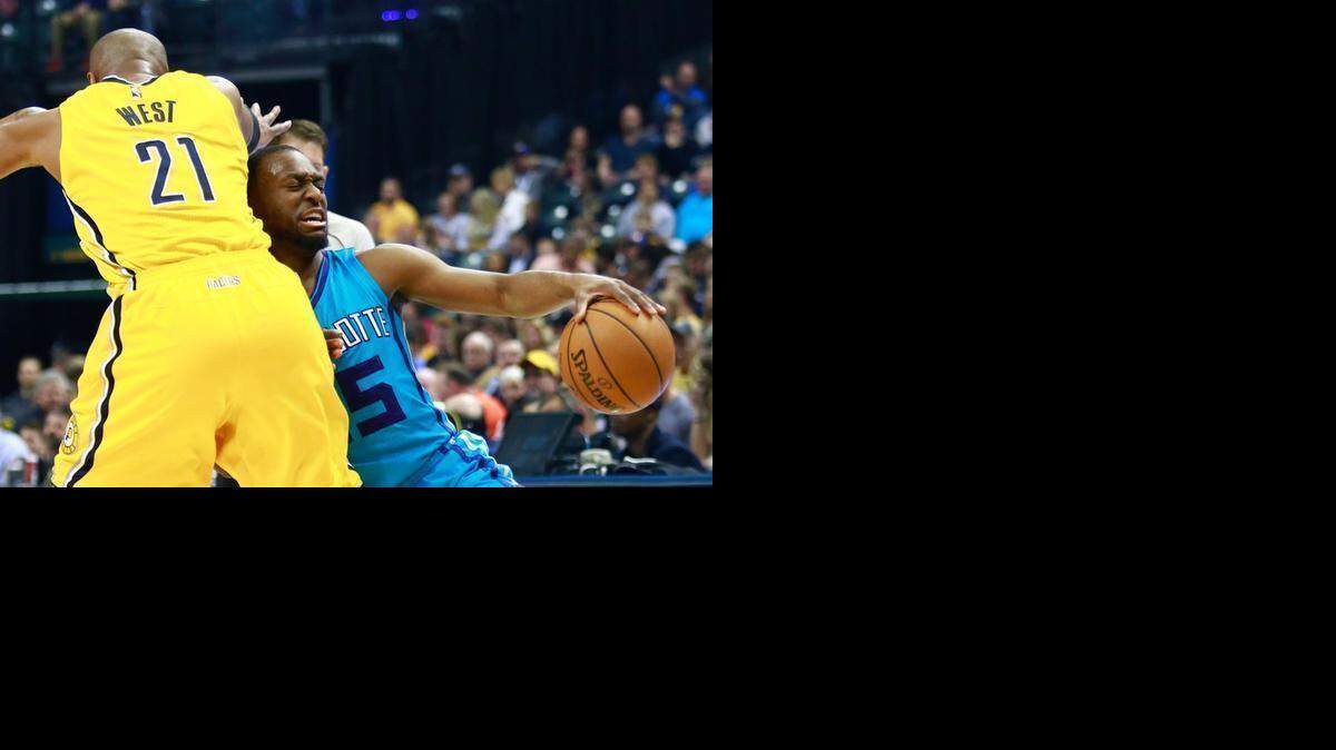 
Charlotte Hornets guard Kemba Walker, right, collides with Indiana Pacers forward David West in the first half of an NBA basketball game, Friday, April 3, 2015, in Indianapolis. 

