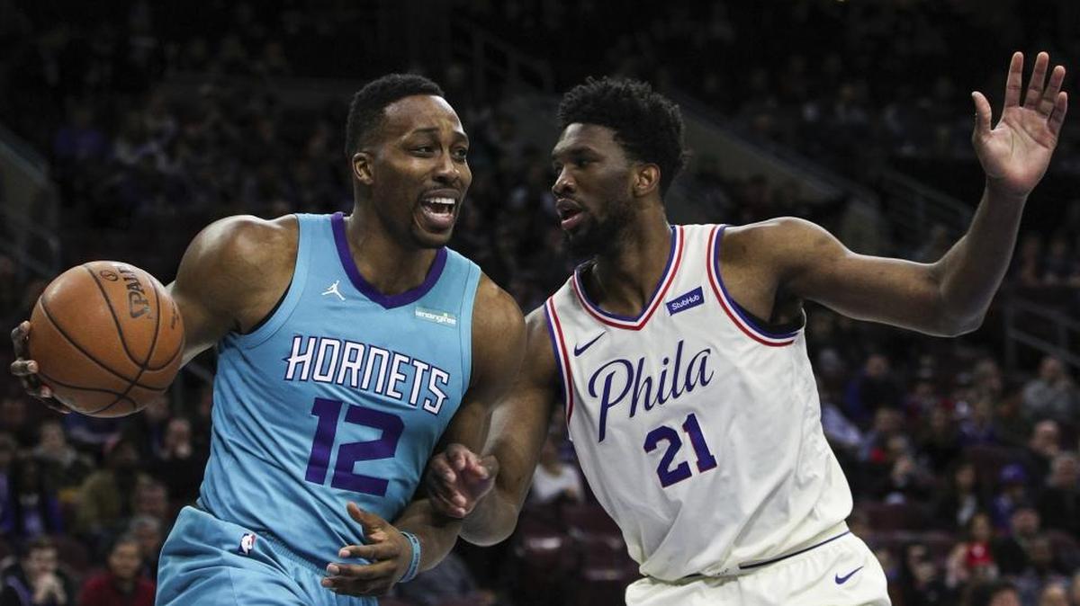 Charlotte Hornets center Dwight Howard, left, drives to the basket as Philadelphia 76ers’ Joel Embiid defends during the first half of Friday’s 110-99 loss at the Wells Fargo Center in Philadelphia.