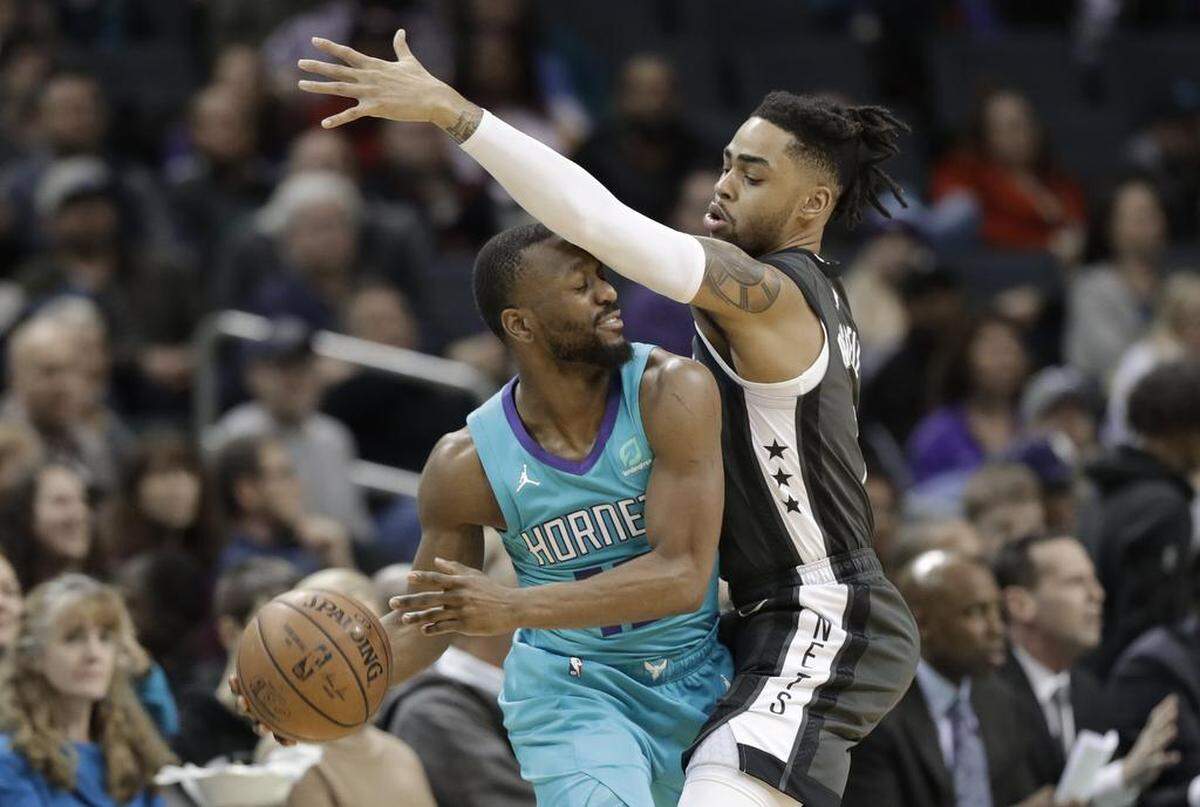 Charlotte Hornets guard Kemba Walker, left, is fouled by Brooklyn Nets guard D’Angelo Russell during Saturday night’s NBA game at Spectrum Coliseum.