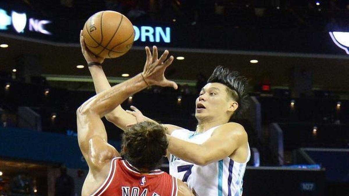 Charlotte Hornets Jeremy Lin on right, carries the ball to the basket against Chicago Bulls Joakim Noah on left, during Monday night's game played at Time Warner Cable Arena Oct. 19, 2015.