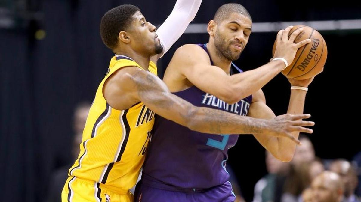 Indiana Pacers forward Paul George defends Charlotte Hornets forward Nicolas Batum in a Feb. 10 game in Indianapolis.