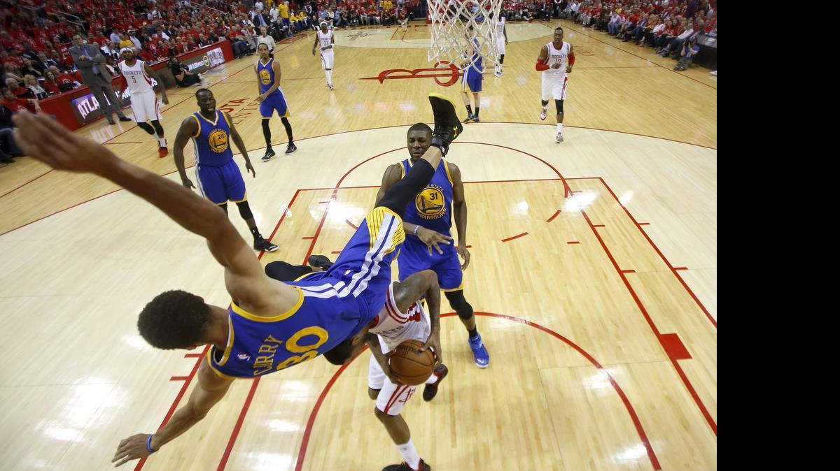 
Golden State Warriors guard Stephen Curry takes scary fall in the second quarter of Monday’s playoff game against the Houston Rockets. He returned in the second half and finished with 23 points in the Warriors’ 128-115 loss.
