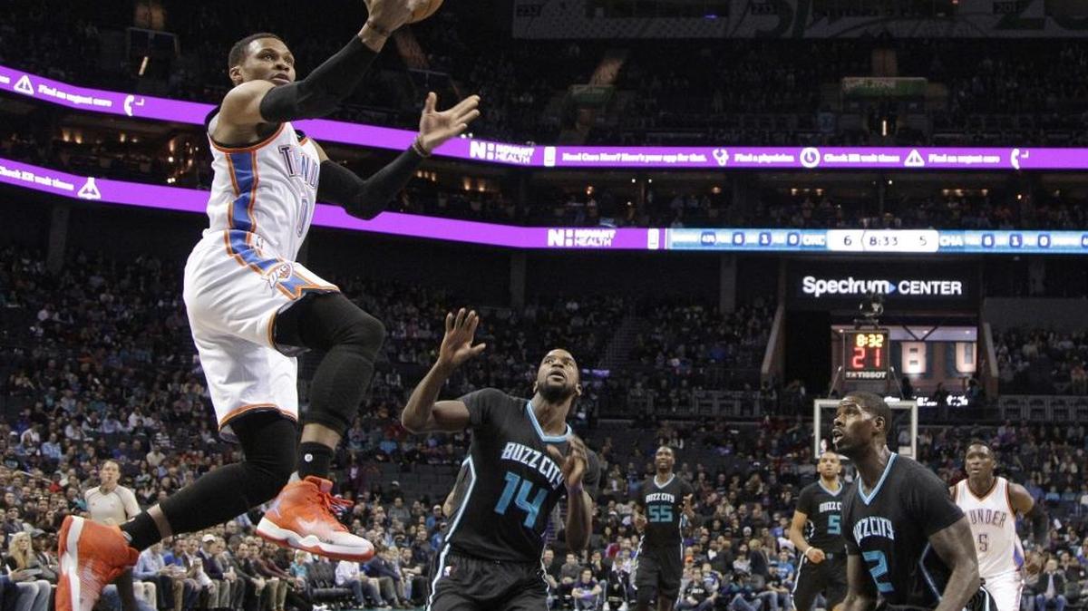 Oklahoma City’s Russell Westbrook drives to the basket past Charlotte’s Michael Kidd-Gilchrist (14) and Marvin Williams (2) during the first half Wednesday. Westbrook finished with 33 points and 15 rebounds in the Thunder’s loss.