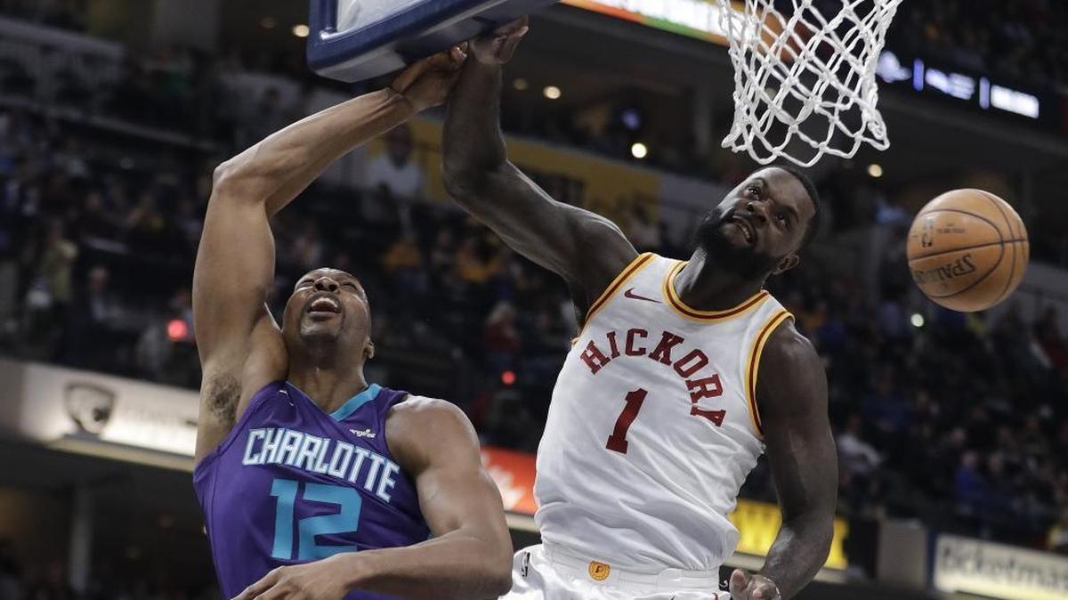 Indiana’s Lance Stephenson (right) blocks the shot of Charlotte Hornets center Dwight Howard in the first half of Tuesday’s NBA game in Indianapolis. Howard finished with 14 points and 17 rebounds in the Hornets’ 119-93 season-ending victory.