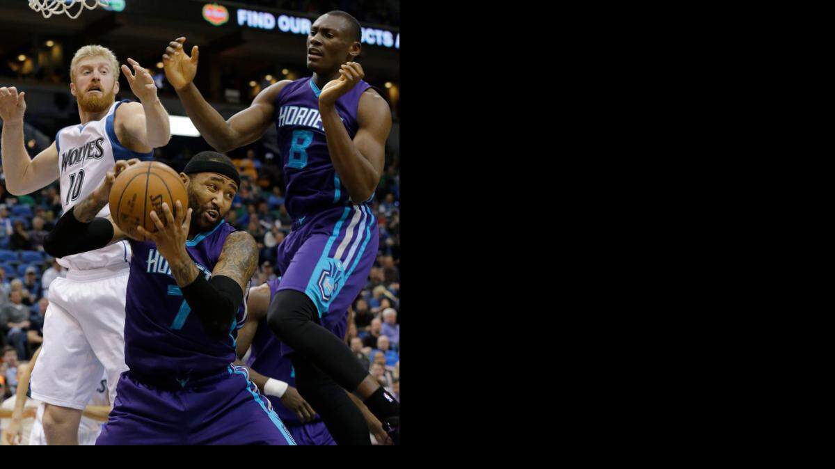 
Charlotte Hornets guard Mo Williams (7) pulls down a rebound in front of Minnesota Timberwolves forward Chase Budinger (10) and Hornets center Bismack Biyombo (8), of Congo, during the second half of an NBA basketball game in Minneapolis, Sunday, March 22, 2015. The Hornets won 109-98. 
