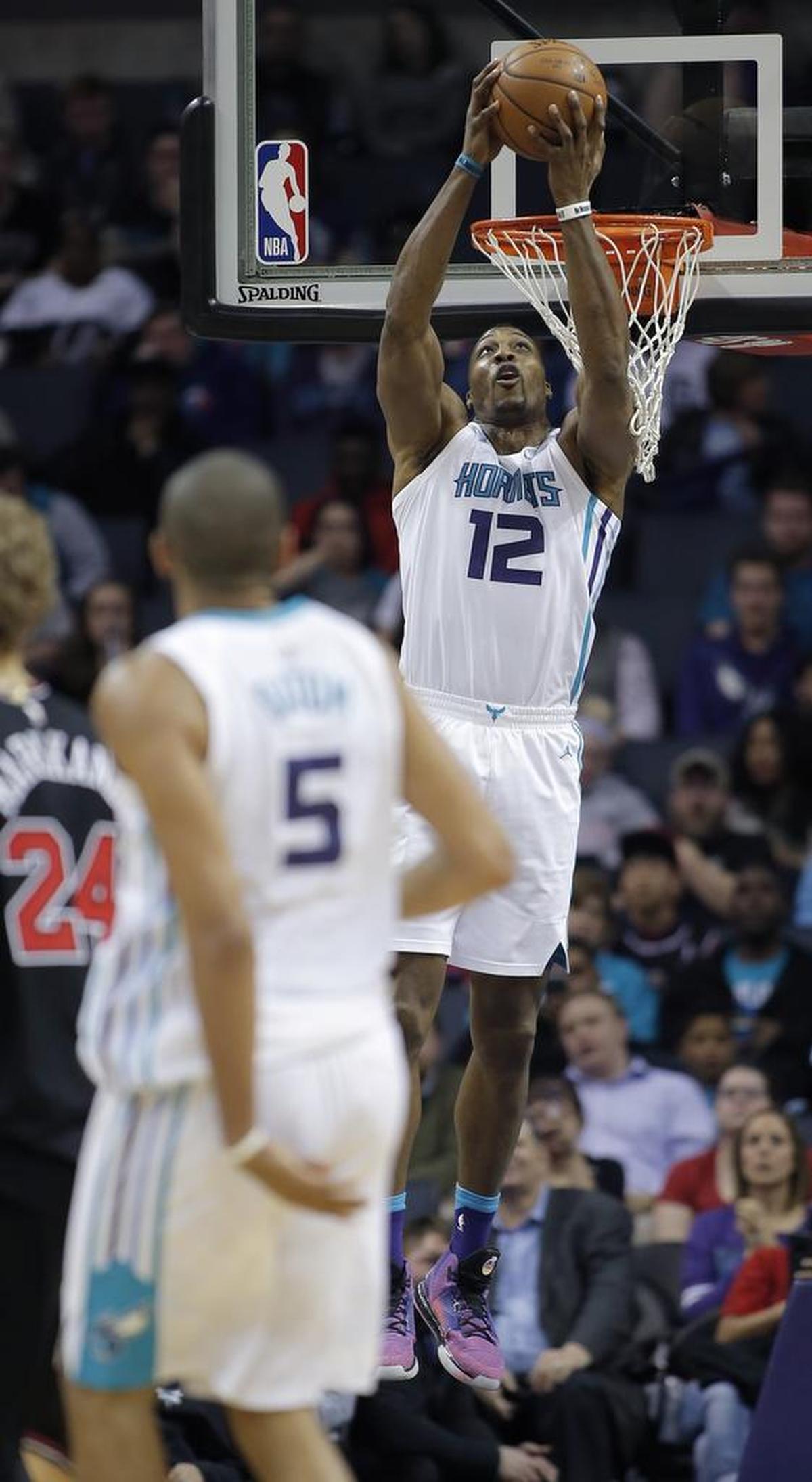 Nic Batum (5) had a season-high 12 assists Tuesday in a 118-103 win over the Chicago Bulls, and a large chunk of those assists went to Dwight Howard (12), like on this alley-oop.