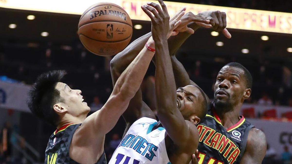 Atlanta Hawks guard Jeremy Lin, left, and teammate Dewayne Dedmon, right, battle Charlotte Hornets forward Michael Kidd-Gilchrist for a loose ball. Lin, who spent one season with the Hornets, scored 19 points off the bench Tuesday night at Spectrum Center in the Hawks’ 113-102 loss.