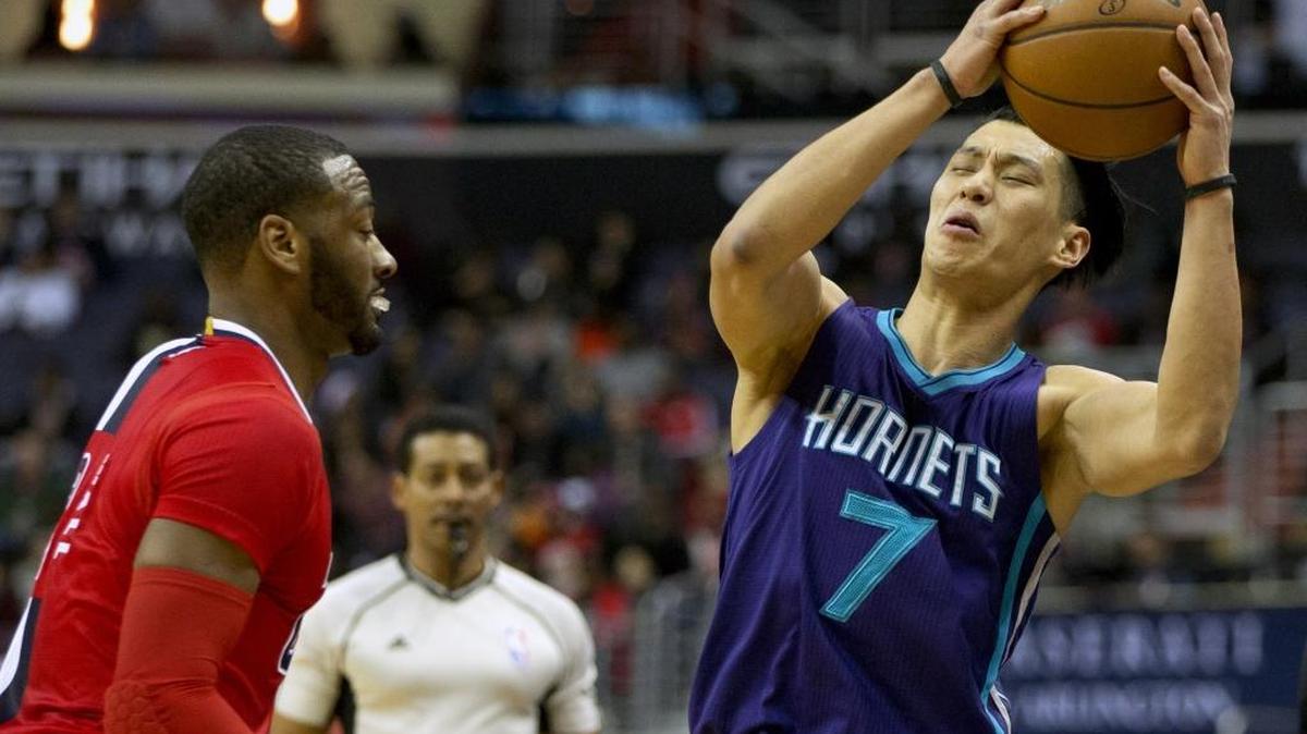 Charlotte Hornets guard Jeremy Lin (7) is temporarily off balance before recovering against Washington Wizards guard John Wall in Saturday’s game.