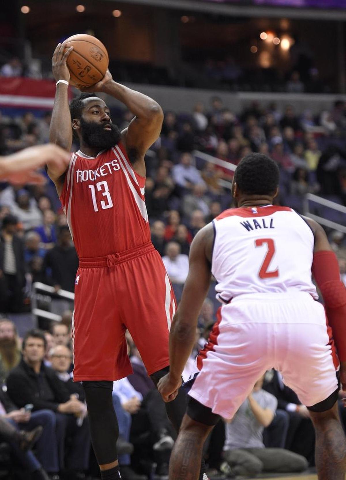 Houston Rockets guard James Harden (13) looks to pass against Washington Wizards guard John Wall (2) during the first half of an NBA basketball game, Wednesday, Dec. 9, 2015, in Washington. (AP Photo/Nick Wass)