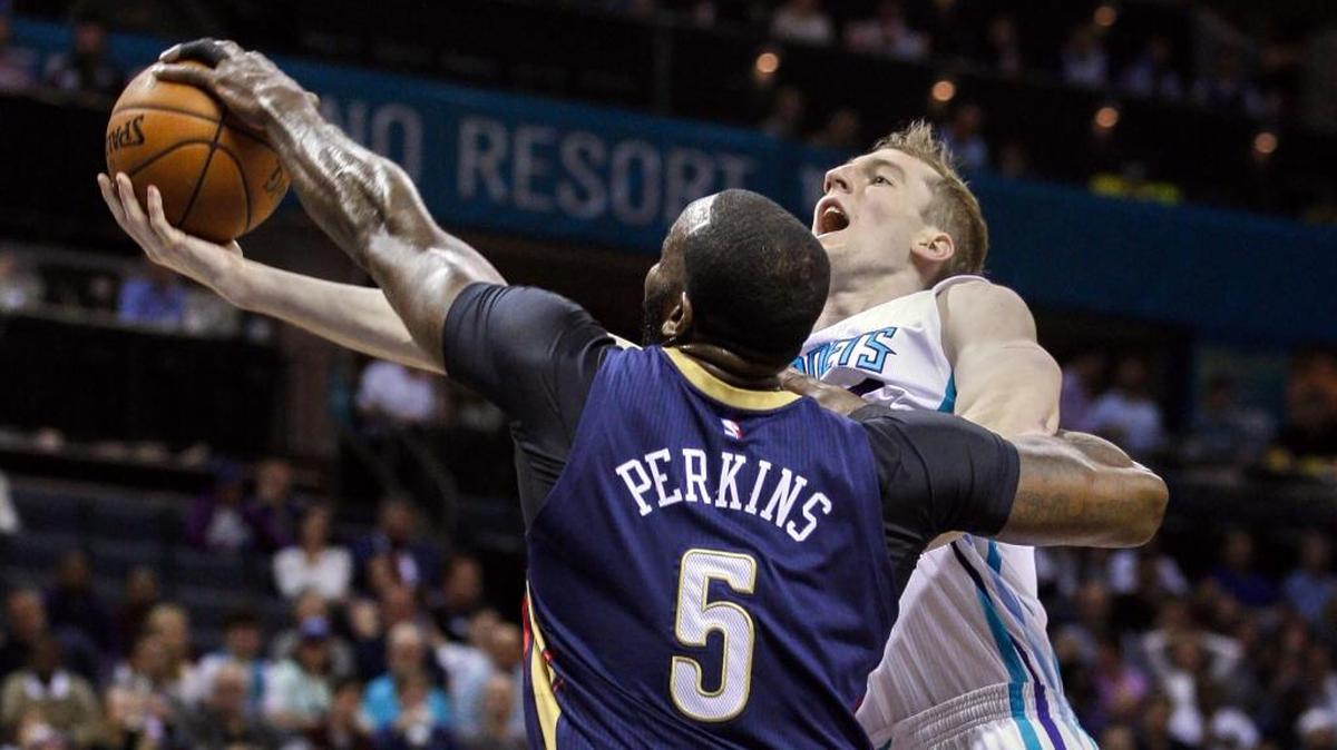 New Orleans Pelicans center Kendrick Perkins, left, blocks shot by Charlotte Hornets center Cody Zeller in the first half of Wednesday’s NBA basketball game in Charlotte.