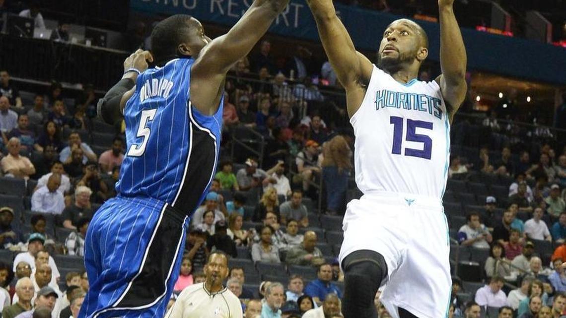 Orlando Magic's Victor Oladipo on left, blocks a shot by Charlotte Hornets guard Kemba Walkerduring Wednesday night's game.