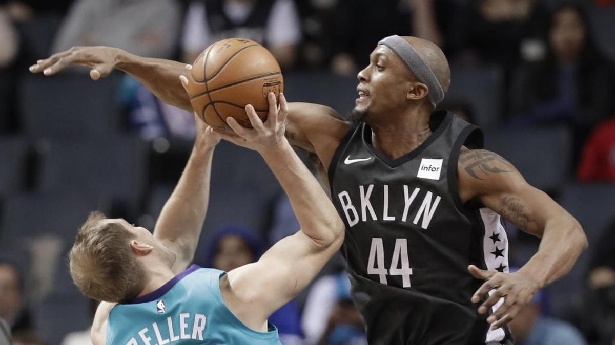 Charlotte Hornets center Cody Zeller (left) goes up for a shot against the Brooklyn Nets' Dante Cunningham in Thursday’s NBA game at Spectrum Center.