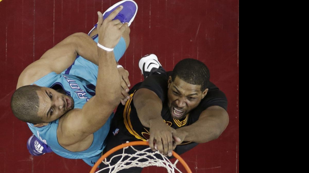 Cleveland Cavaliers' Tristan Thompson, right, dunks the ball against Charlotte Hornets forward Nicolas Batum in Sunday’s game in Cleveland.