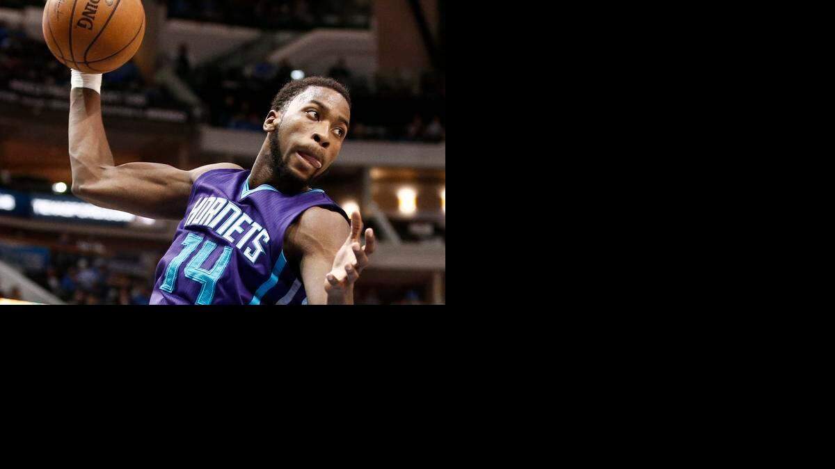 
Charlotte Hornets forward Michael Kidd-Gilchrist rebounds against the Dallas Mavericks, Feb. 22, 2015, in Dallas.
