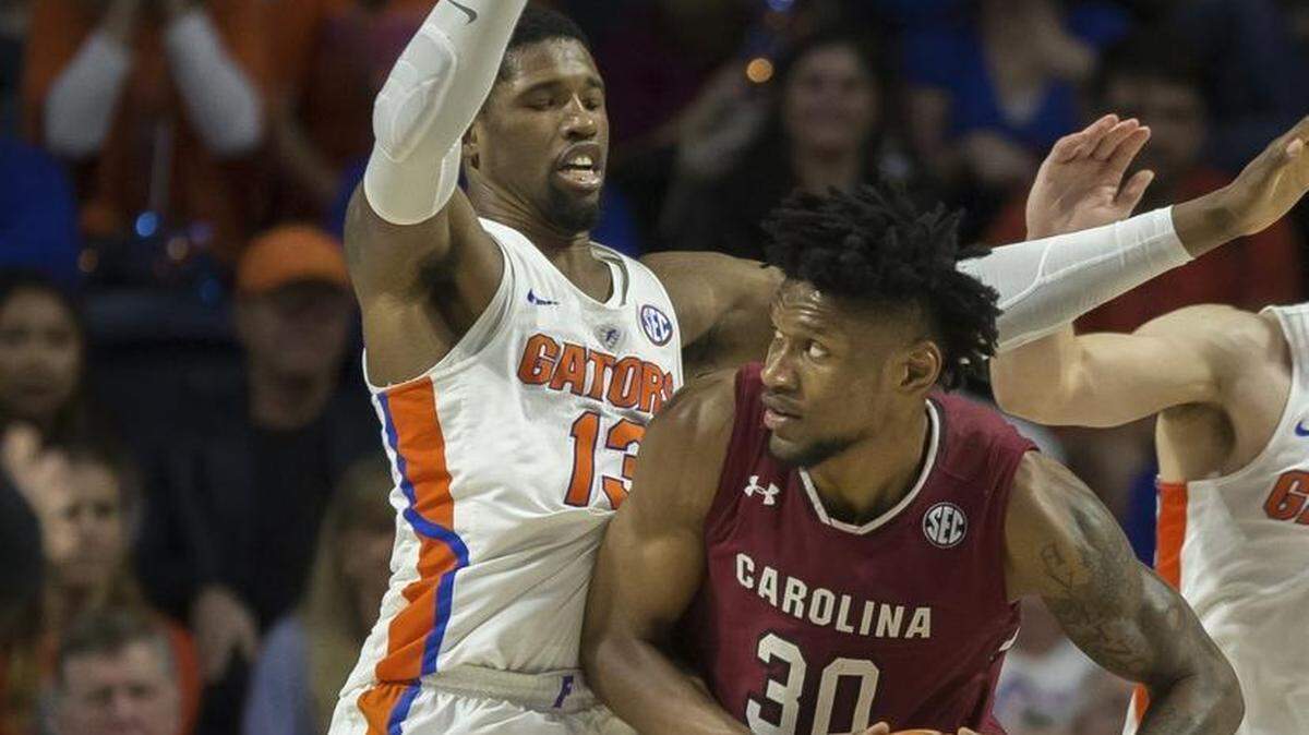 South Carolina forward Chris Silva (30) looks to shoot over Florida forward Kevarrius Hayes (13) during the second half of Wednesday’s game in Gainesville, Fla. South Carolina won 77-72.