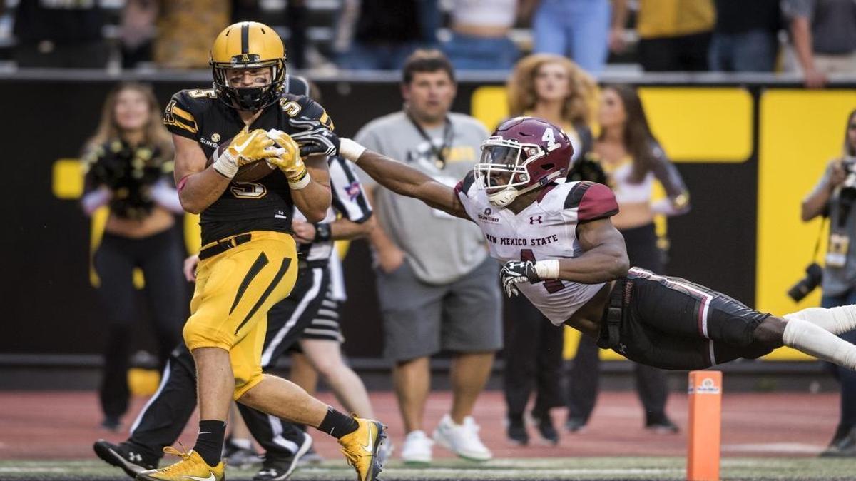 Appalachian State freshman wide receiver Thomas Hennigan (5) catches a touchdown pass under coverage from New Mexico State junior defensive back DeMarcus Owens (4) during the fourth quarter of Saturday’s game in Boone.