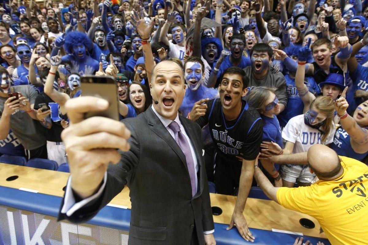 Jay Bilas takes a photo with the Cameron Crazies at Duke. Bilas played for the Blue Devils from 1982-86, starting all four years.
