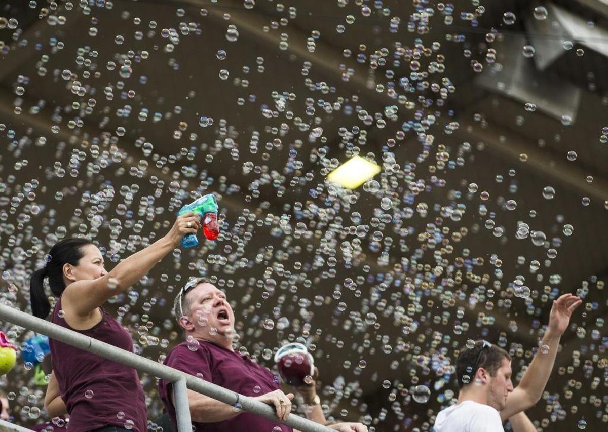 Texas A&M fans celebrate Friday’s win over Davidson in 15 innings during an NCAA college baseball tournament super regional game.