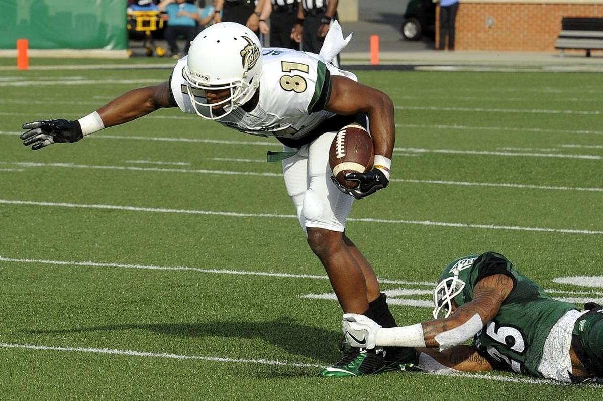Charlotte 49ers redshirt senior wide receiver Trent Bostick (81) tries to slip a tackle during Saturday’s spring football game at Richardson Stadium.