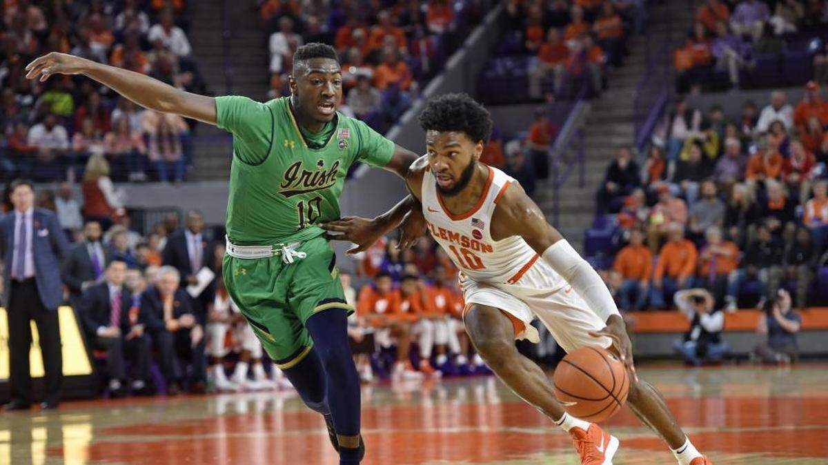 Clemson’s Gabe DeVoe, right, drives against Notre Dame’s T.J. Gibbs Jr. during the first half of Saturday’s game. DeVoe scored 17 points as the Tigers beat the visiting Irish, 67-58, for the first time ever.