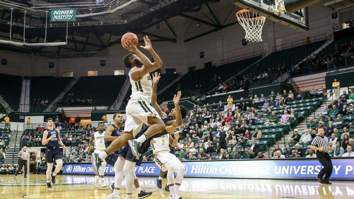 Marcus Evans of Rice takes a charge from Charlotte’s Anthony Vanhook during Monday night’s game.