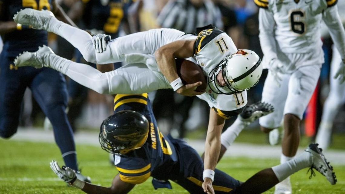 Appalachian State quarterback Taylor Lamb (11) is upended after a big gain by Toledo cornerback Trevon Mathis (6) during Saturday’s 31-28 win against Toledo in Montgomery, Ala.