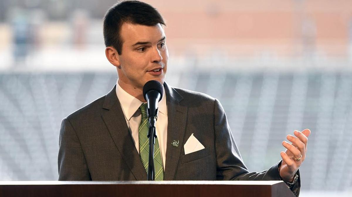 New Charlotte 49ers football coach Will Healy said he will run a spread-option offense and a defense that focuses on rushing the passer.