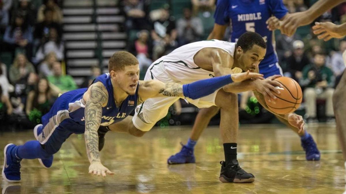 Middle Tennessee guard Tyrik Dixon, left, and Charlotte guard Jon Davis dive for a ball at midcourt in Saturday’s Conference USA basketball game at Halton Arena. The 49ers fell 78-73 to the Blue Raiders, who remain on top of the C-USA standings.