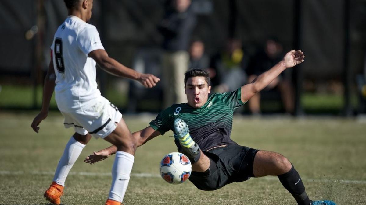 Jacori Hayes of Wake Forest, left, defends as Max Rodriguez of Charlotte slides after the ball during Sunday’s game against Wake Forest.