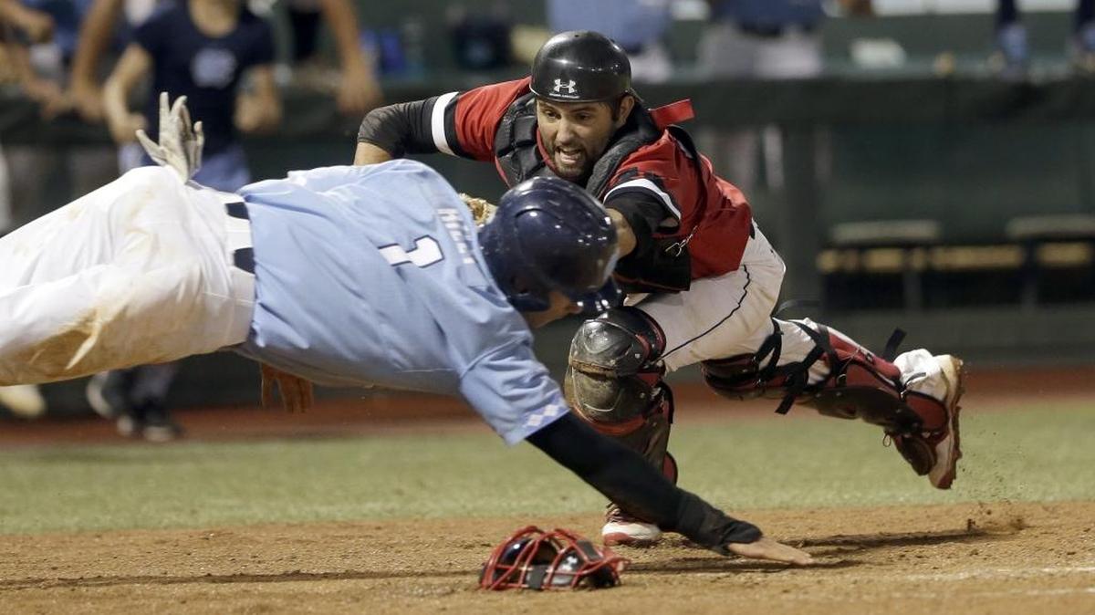 Davidson catcher Jake Sidwell (right) tags out North Carolina’s Brandon Riley at home plate in the ninth inning of last Sunday’s regional final in Chapel Hill. Davidson won 2-1 to advance to this weekend’s NCAA baseball super regional at Texas A&M.