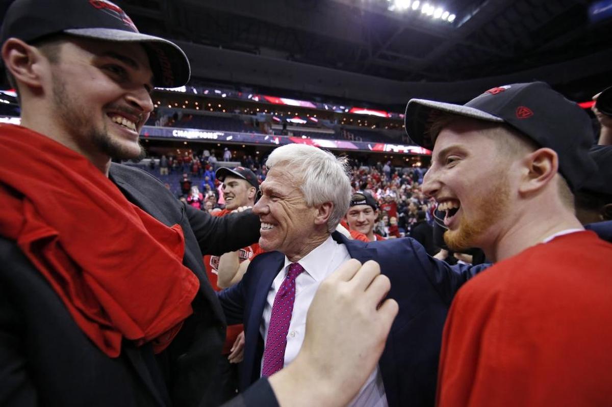 Davidson head coach Bob McKillop, center, celebrates with his team after the Wildcats beat Rhode Island in the Atlantic 10 Conference tournament championship game on Sunday.
