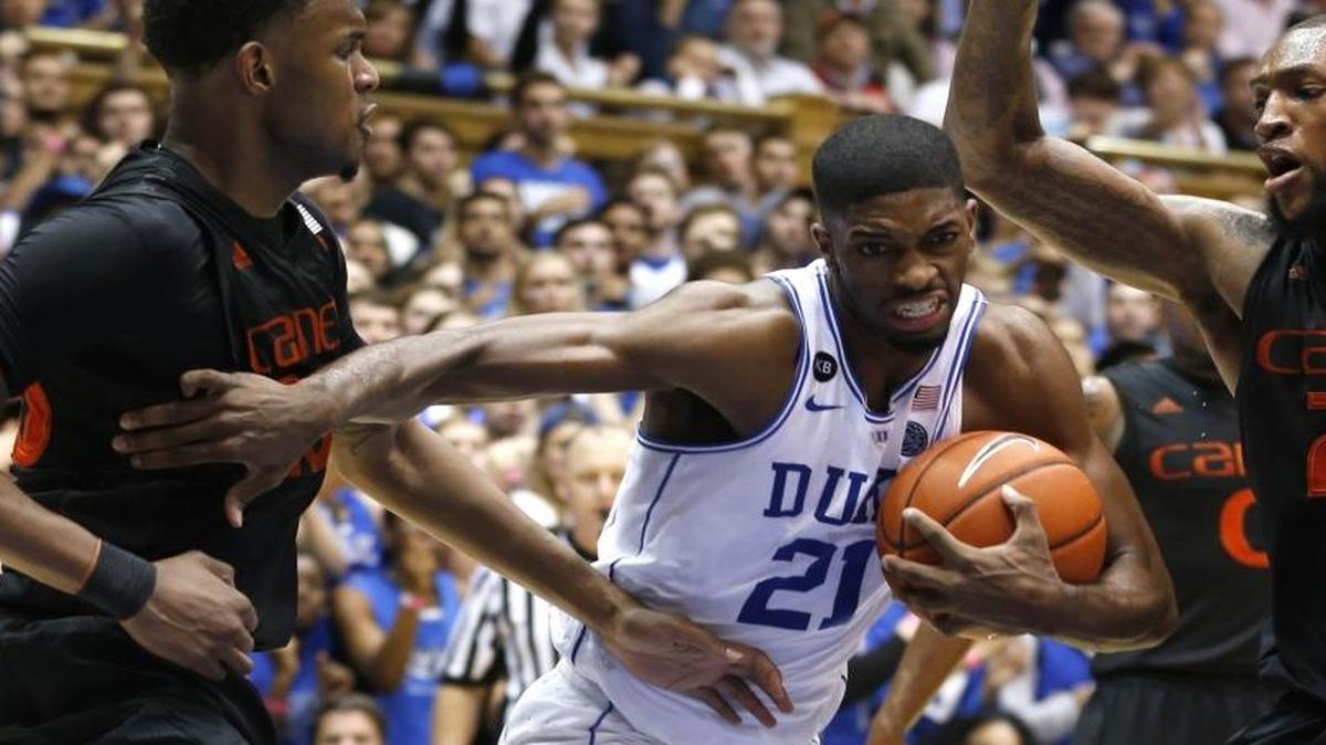 Duke's Amile Jefferson, center, drives between Miami's Dewan Huell, left, and Miami's Kamari Murphy, right, during the second half of Saturday’s game. Jefferson had 12 rebounds in Duke’s come-from-behind win.