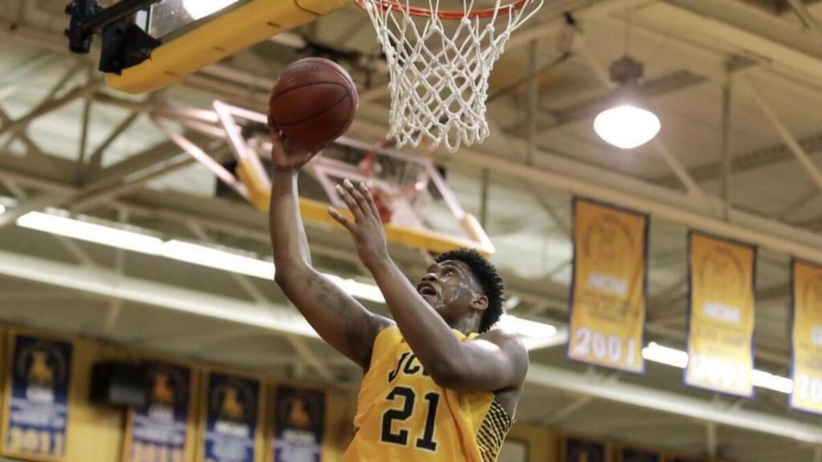 Johnson C. Smith’s Arthur Bennett sticks back an offensive rebound. Shaw rallied to beat J.C. Smith, 78-75, Saturday at Brayboy Gymnasium.